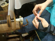 [Spinning silk thread from a cocoon]